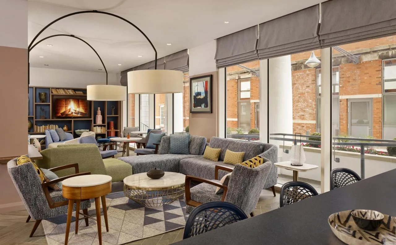 a living room with couches and chairs at the Islington aparthotel