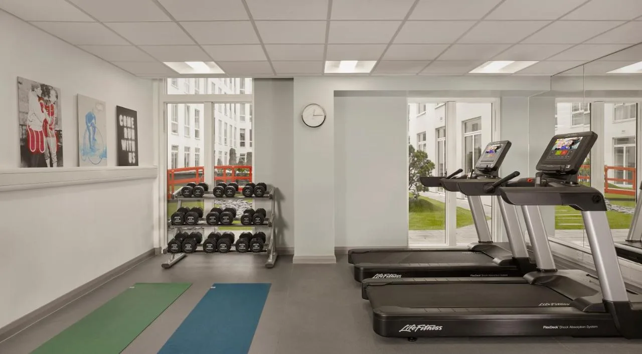 a gym with two treadmills at the Shelley Place aparthotel
