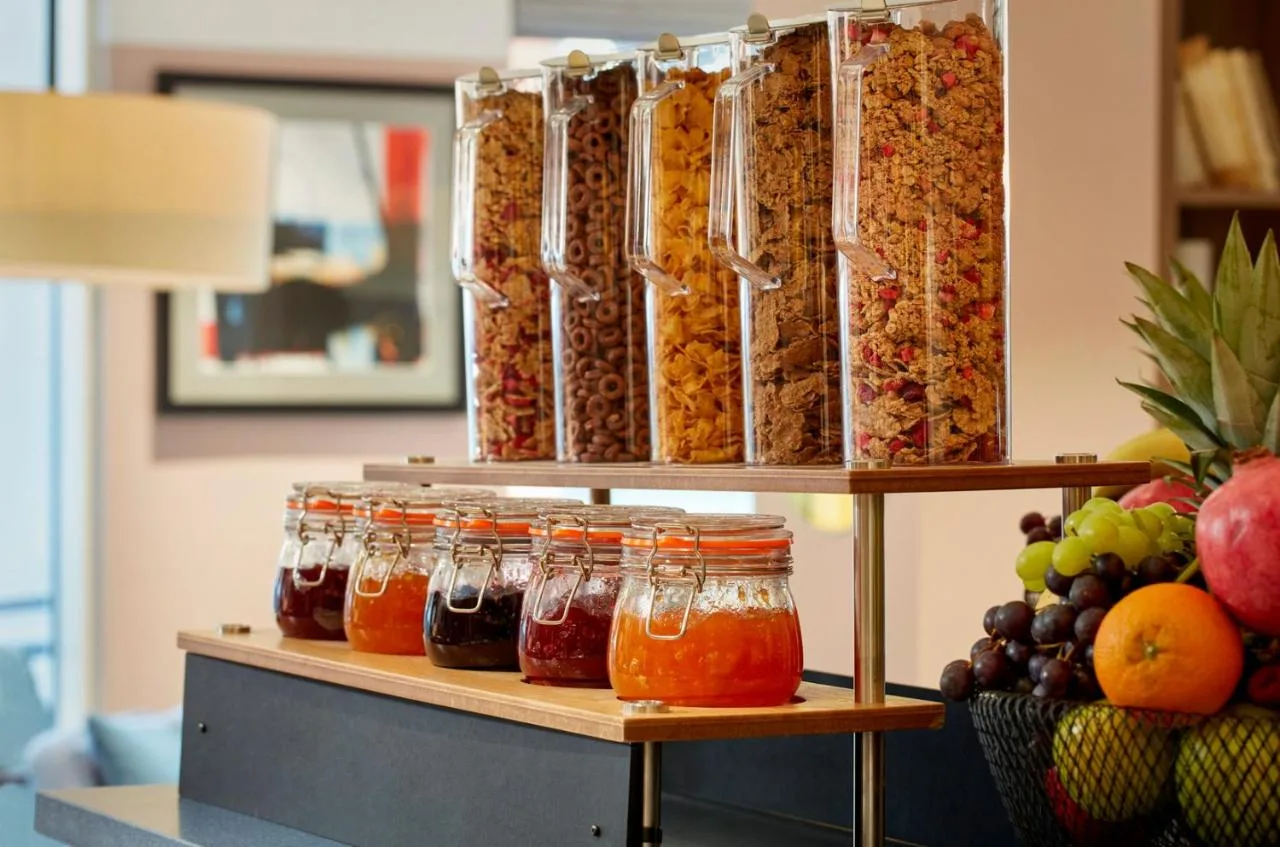 a display of jars of food and fruit at breakfast